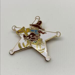 A cowboy on a Rockinghorse sheriff star pin